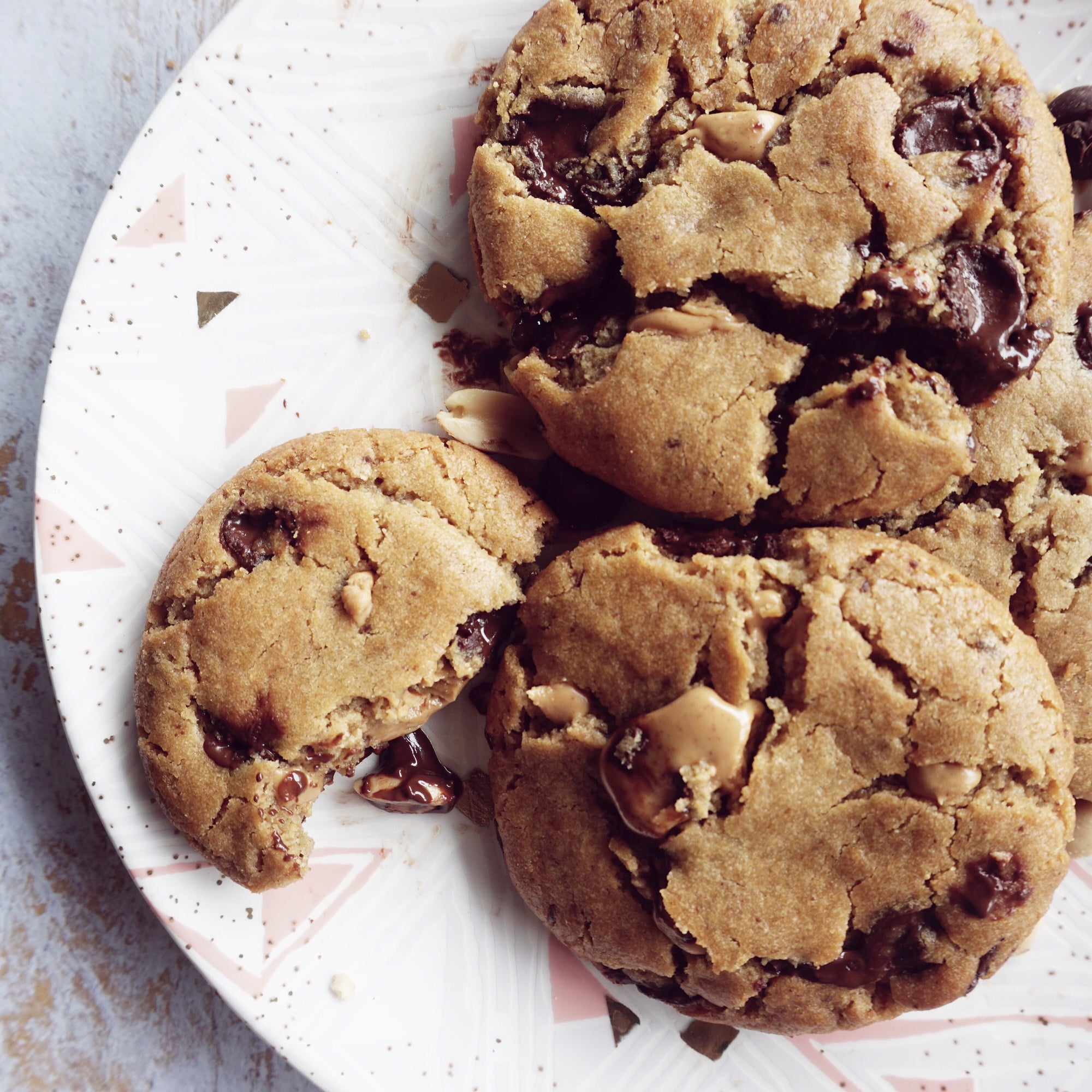 The Naughty Cookie Vegan Peanut Butter Chocolate Chip cookies. Consists of Organic Peanut Butter and Chocolate Chips mixed into The Naughty Cookie signature cookie dough and dusted off with Sea Salt Flakes. 