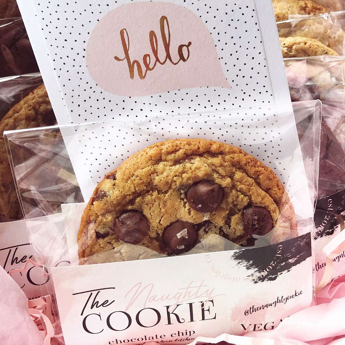 The Naughty Cookie Chocolate Chip Cookie in individual cookie sleeve with hello note card