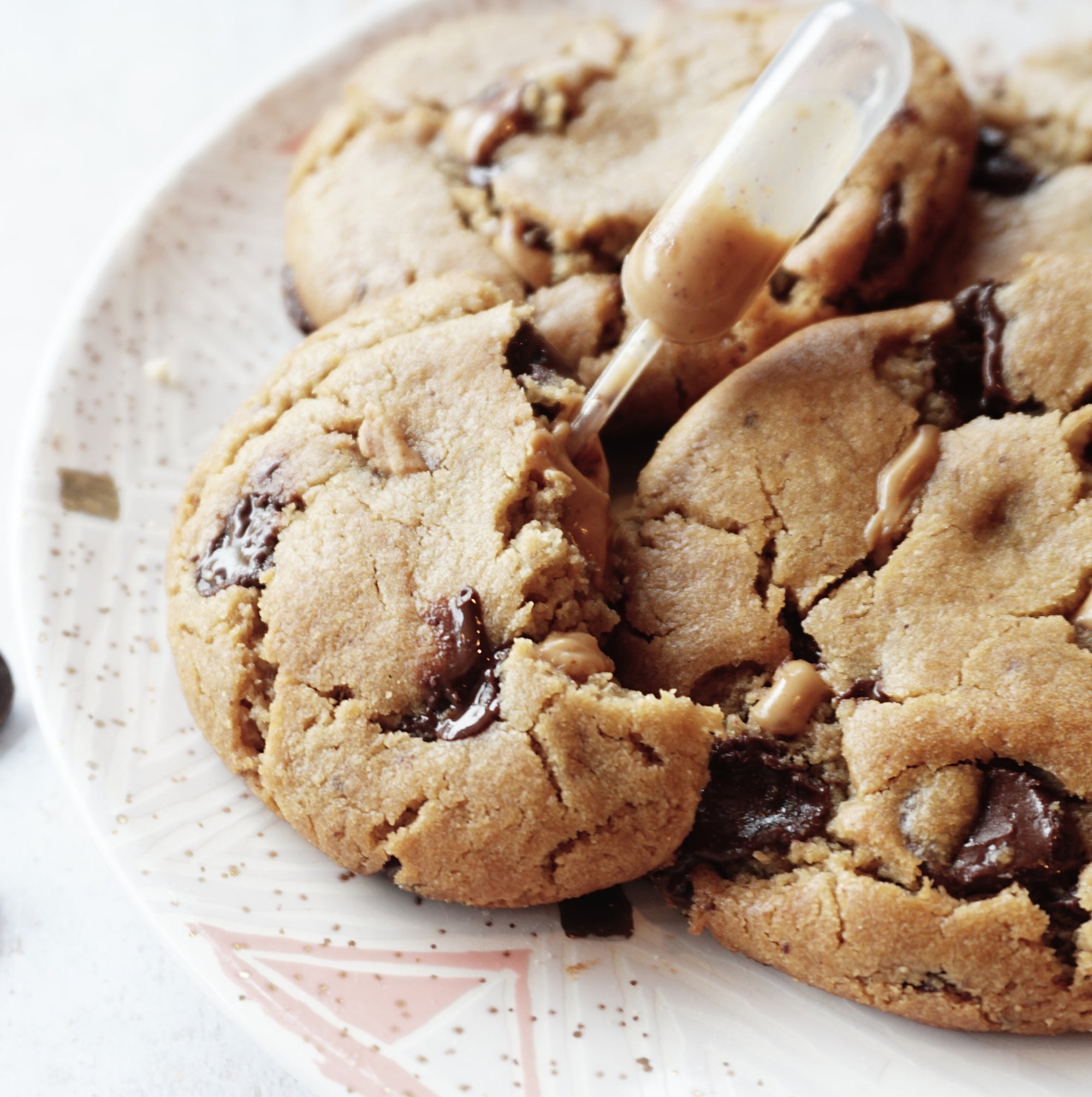 The Naughty Cookie Vegan Peanut Butter Chocolate Chip cookies. Consists of Organic Peanut Butter and Chocolate Chips mixed into The Naughty Cookie signature cookie dough and dusted off with Sea Salt Flakes. 