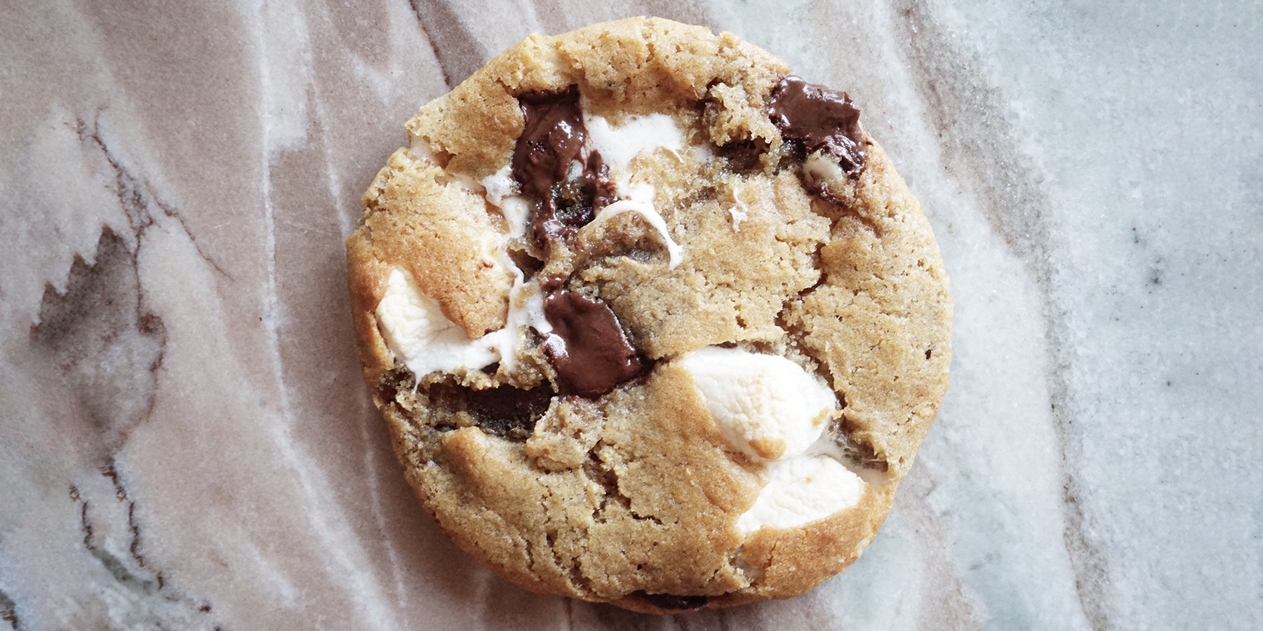 The Naughty Cookie Vegan Ooey Gooey S'mores Cookie! Consists of Marshmallows, Chocolate, and Graham Crackers. 